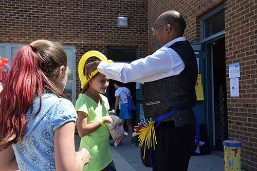 Pravin performing at an elementary school