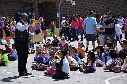 Pravin performing at an elementary school